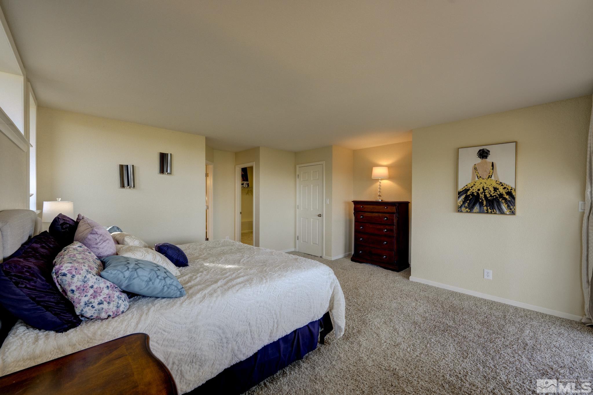 3760 Paradise View Carson City, NV 89703 - Photo 16 of 40 a bedroom with a bed and a view of kitchen