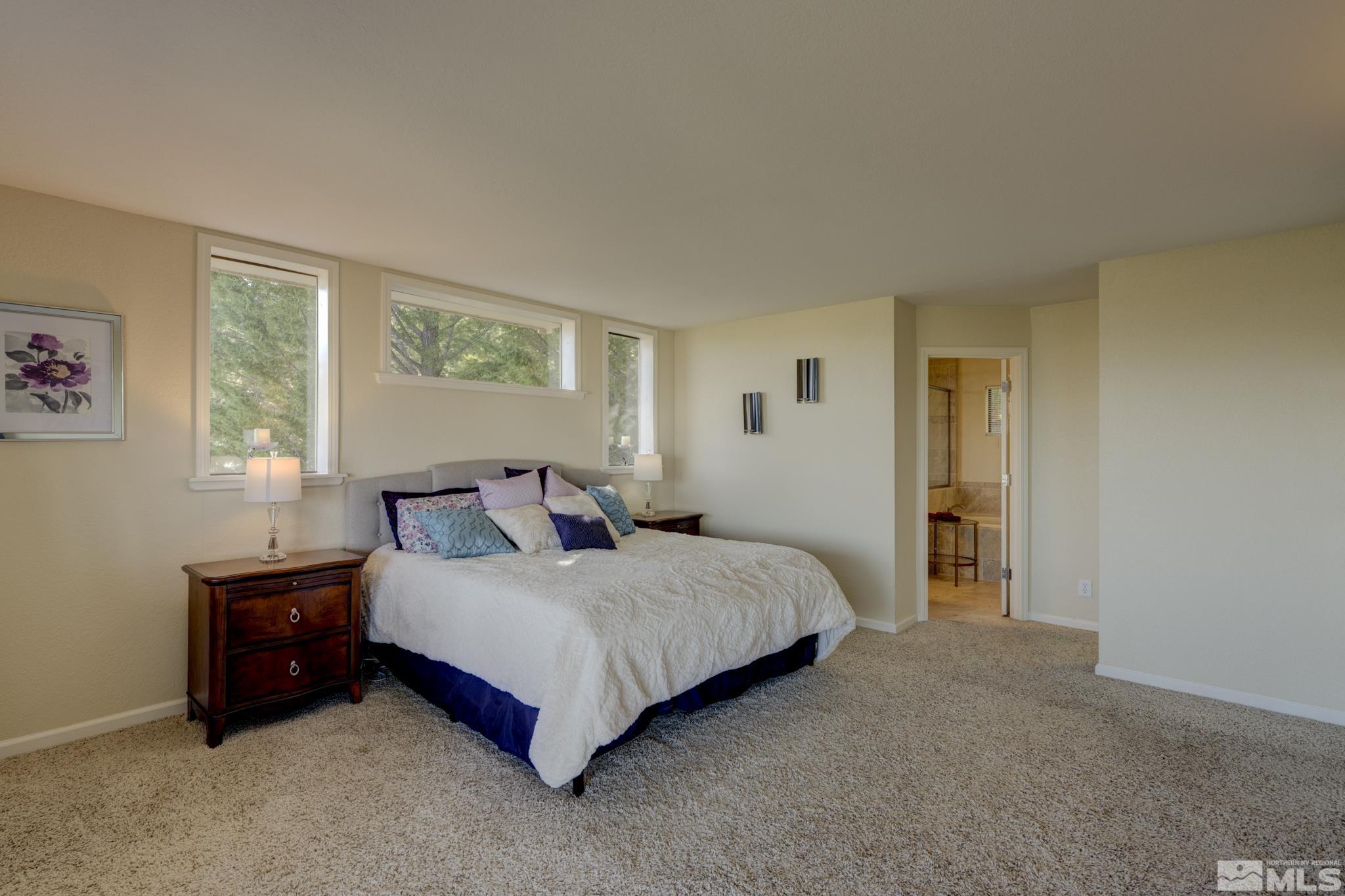 3760 Paradise View Carson City, NV 89703 - Photo 17 of 40 a bedroom with a bed lamp and a window