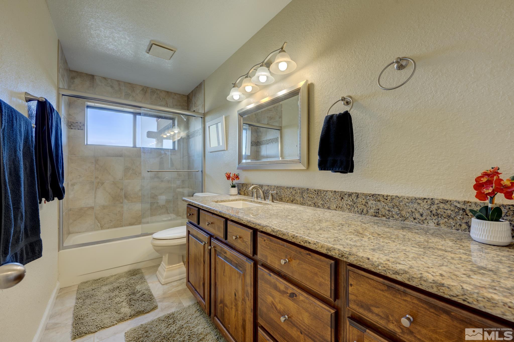 3760 Paradise View Carson City, NV 89703 - Photo 19 of 40 a bathroom with a sink a toilet and shower