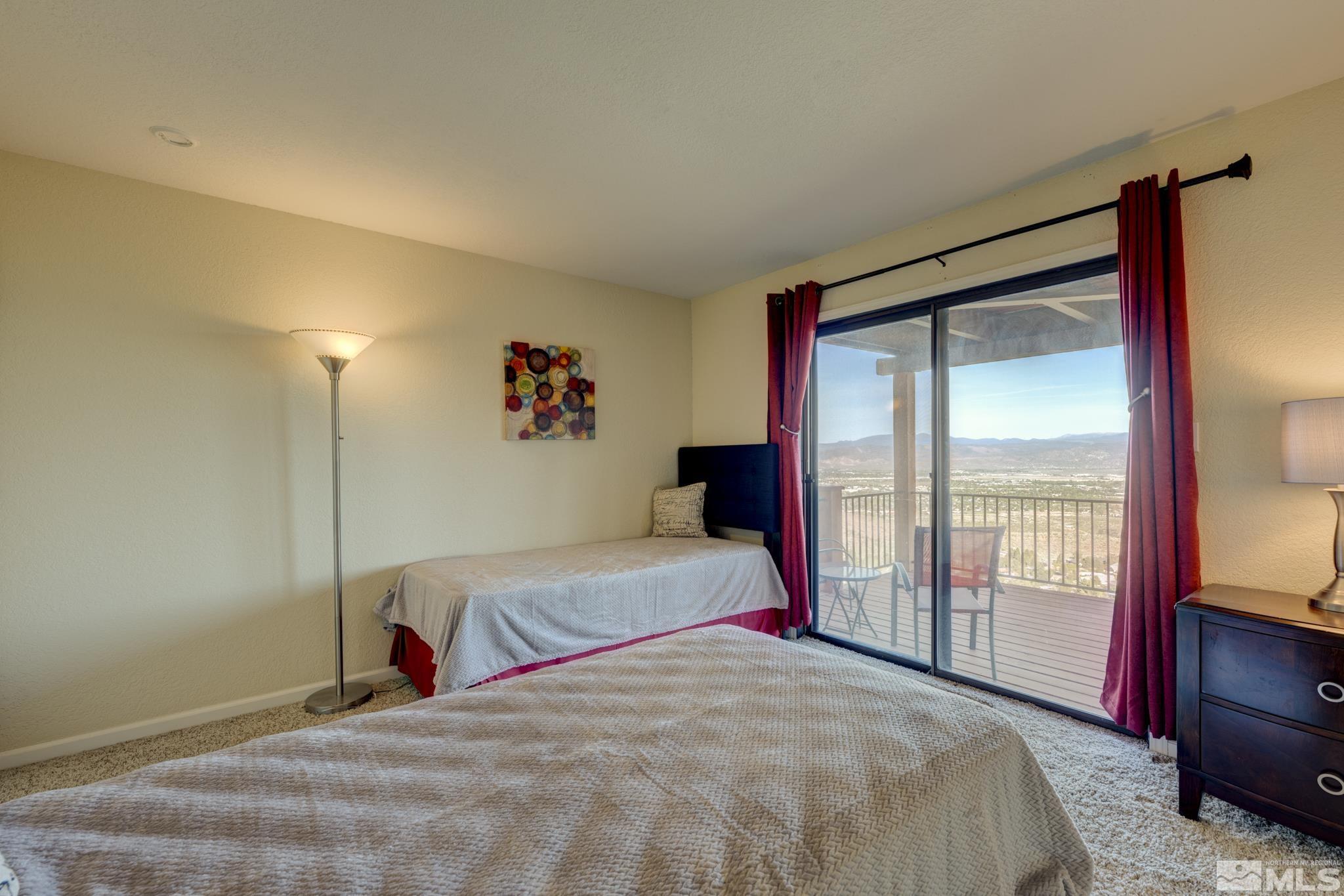 3760 Paradise View Carson City, NV 89703 - Photo 27 of 40 a bedroom with a bed and a large mirror