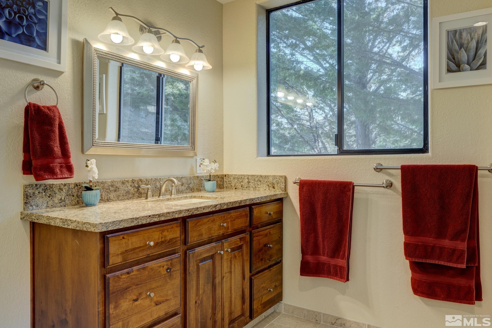 3760 Paradise View Carson City, NV 89703 - Photo 29 of 40 a bathroom with a sink vanity and a mirror