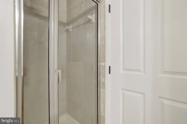 a bathroom with a glass shower door
