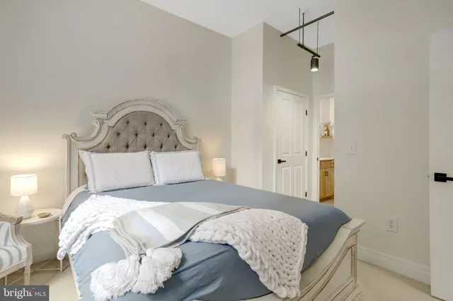 a bedroom with a bed and a mirror