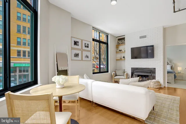 a living room with fireplace furniture and a flat screen tv
