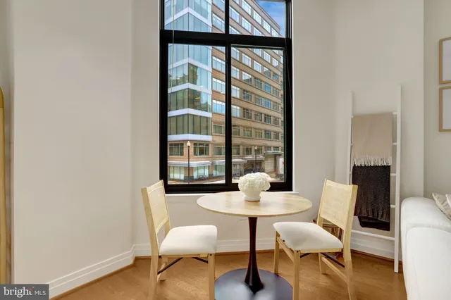 a view of a dining room with furniture window and wooden floor