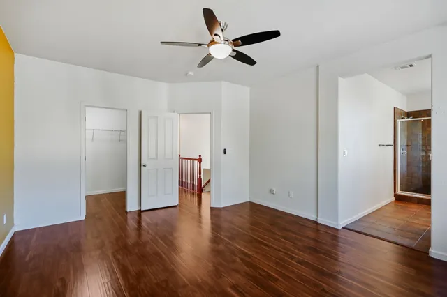 a view of an empty room with wooden floor
