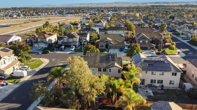 an aerial view of a houses with a lake view