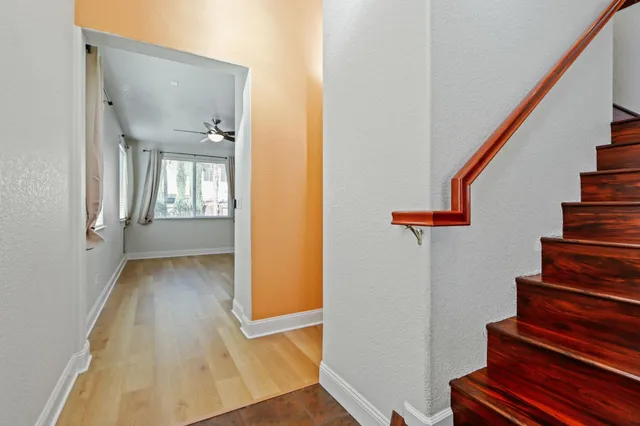 a view of entryway and hall with wooden floor