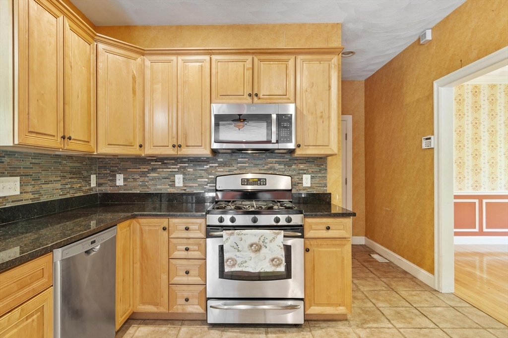 4 Forest Street Georgetown, MA 01833 - Photo 13 of 37 a kitchen with stainless steel appliances granite countertop a stove and a refrigerator