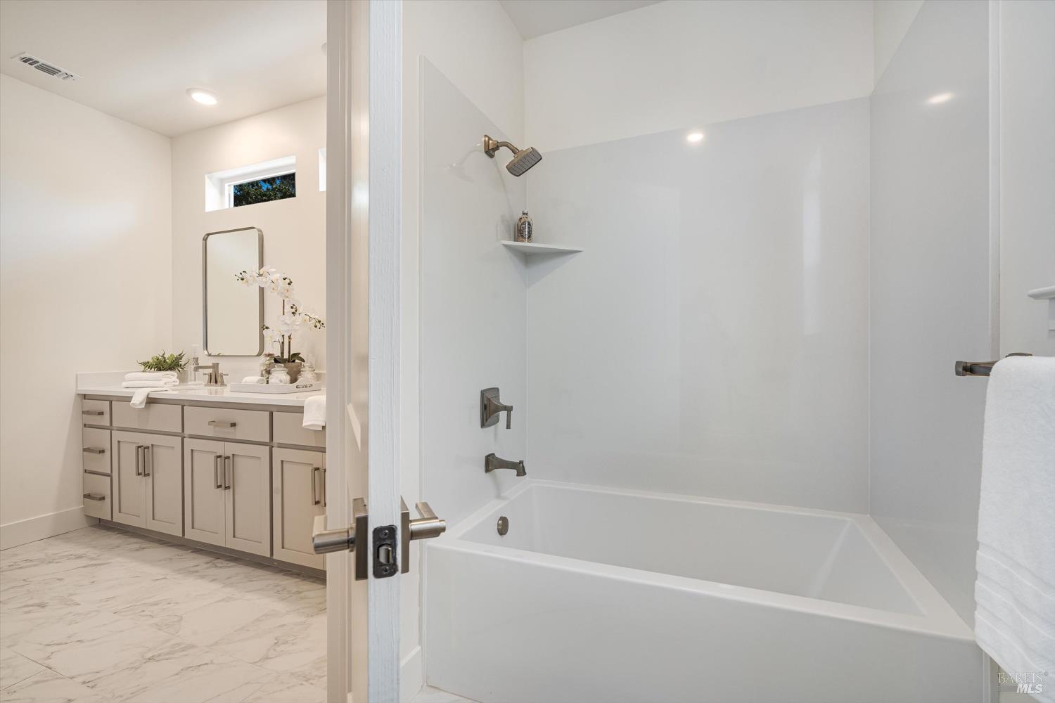 107 Grace Lane Napa, CA 94559 - Photo 34 of 39 a bathroom with a tub sink vanity granite and shower