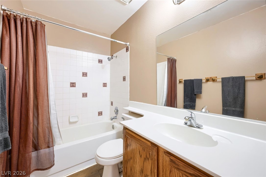2322 Sabroso Street Las Vegas, NV 89156 - Photo 12 of 17 Functional full bathroom featuring a tub-shower combination with tiled surround and a single vanity.