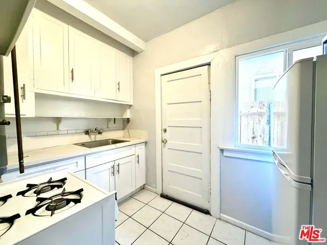 a kitchen with stainless steel appliances a refrigerator and a stove