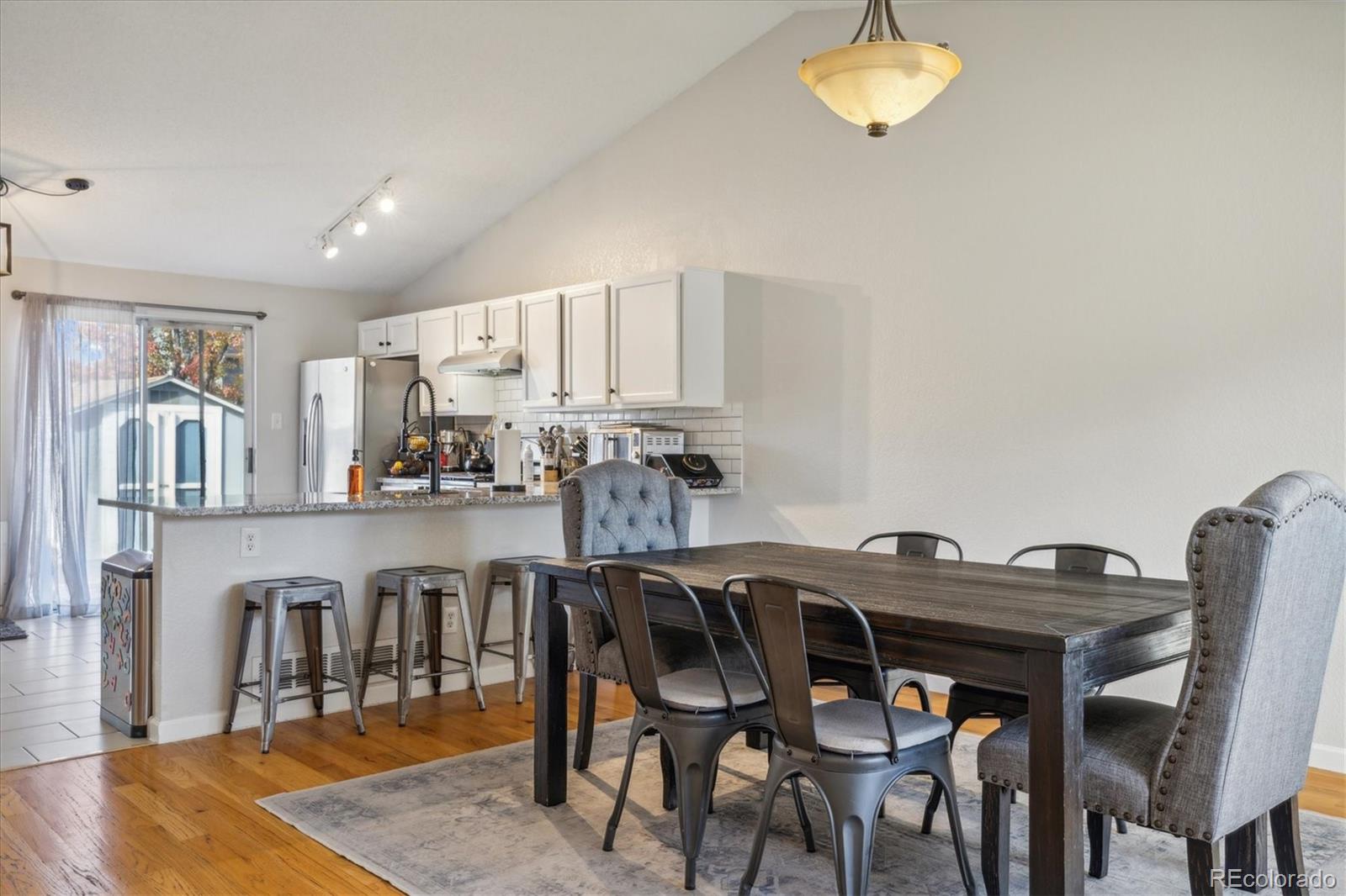 12195 Grape Street Thornton, CO 80241 - Photo 1 of 26 a view of a dining room with furniture and wooden floor