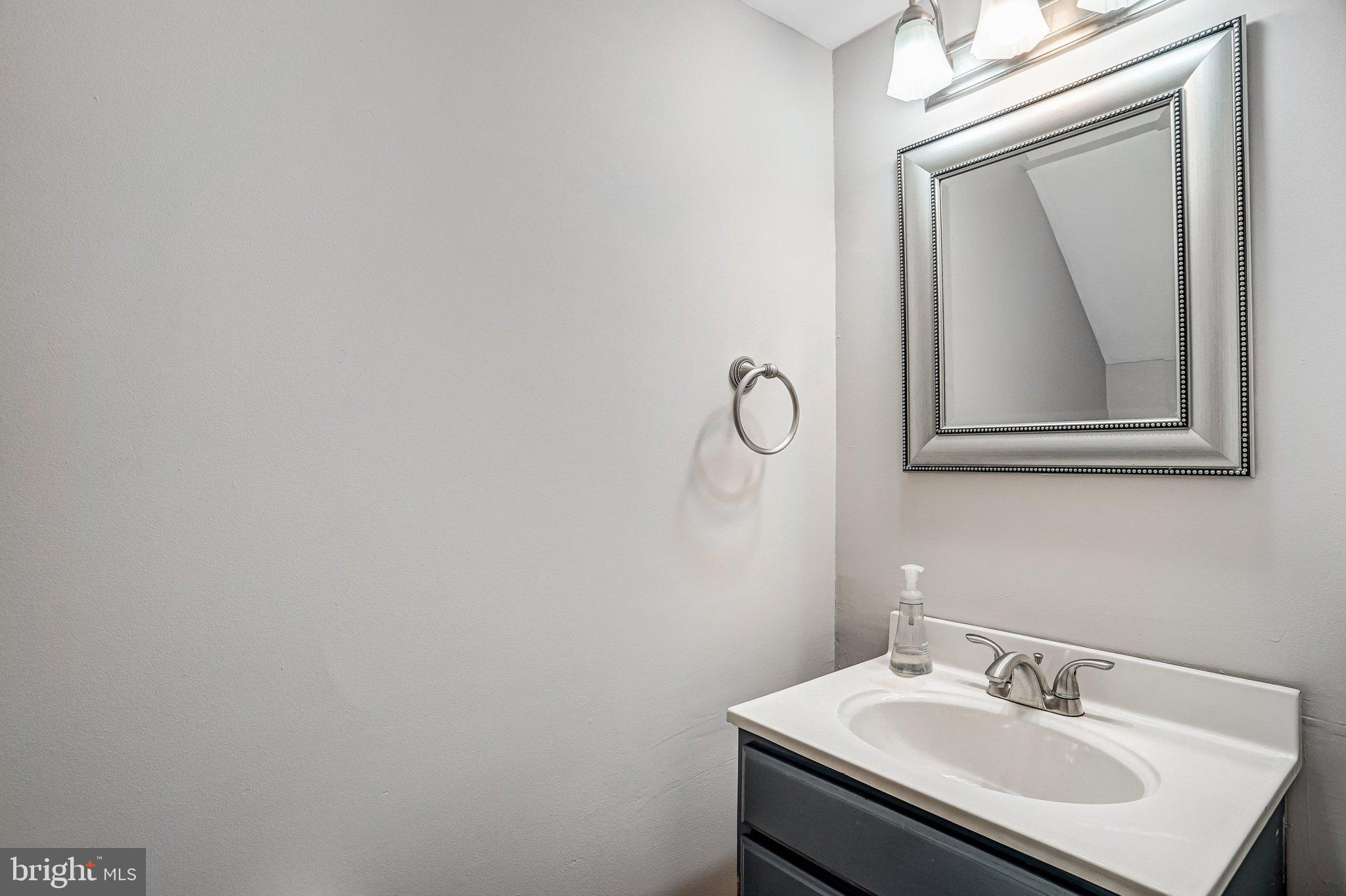 8396 Forrester Boulevard, Unit 555 Springfield, VA 22152 - Photo 12 of 24 a bathroom with a sink vanity and mirror