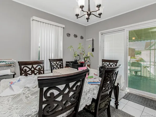 a view of a dining room with furniture and a chandelier