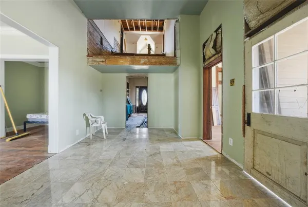 a view of a hallway with paintings on the wall