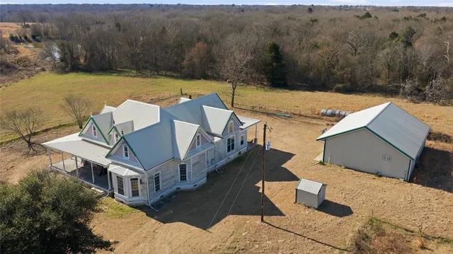 an aerial view of a house with a yard