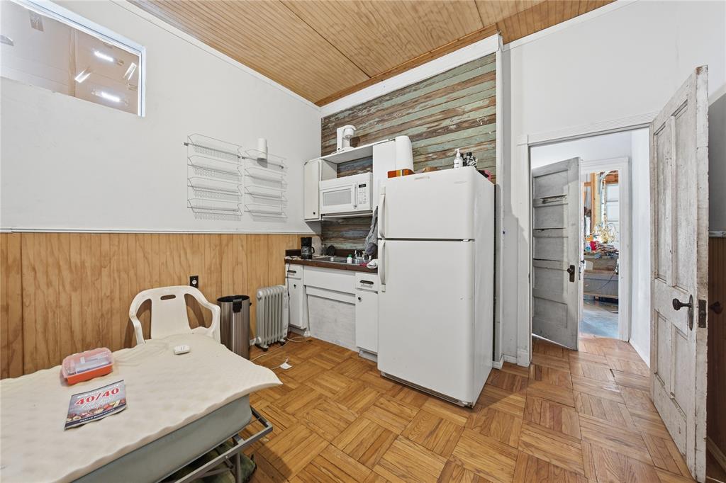 8640 Highway 198 Canton, TX 75103 - Photo 34 of 40 a kitchen with a refrigerator a stove top oven and cabinets