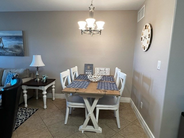 2290 North Fulton Beach Road, Unit B317 Rockport, TX 78382 - Photo 10 of 40 a view of a dining room with furniture and chandelier