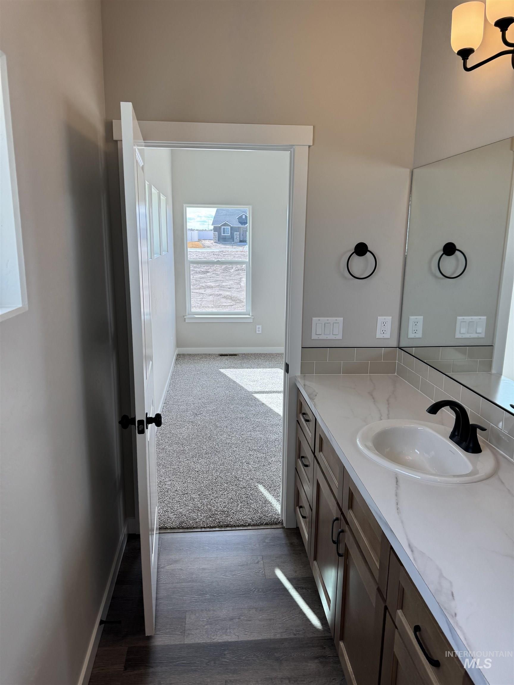 2064 Harrison Street South Twin Falls, ID 83301 - Photo 18 of 29 Half bath with vanity, dark carpet, and dark wood-type flooring