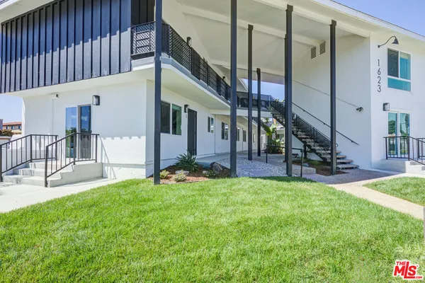 a view of an house with backyard and a patio