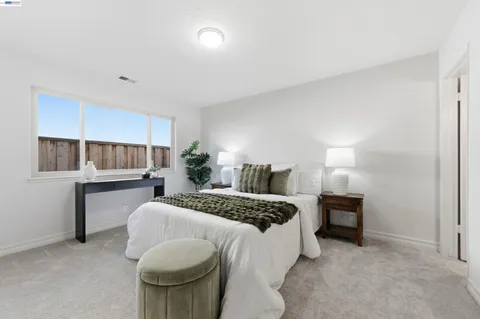 a bedroom with a bed and a lamp