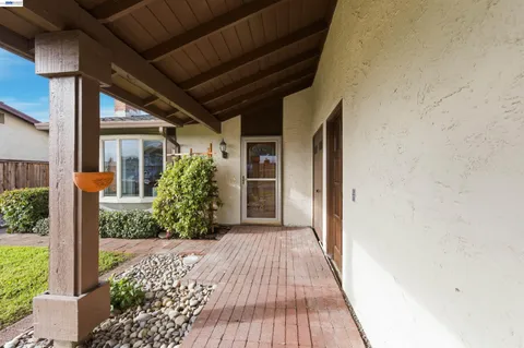 a view of a porch with wooden floor and a yard