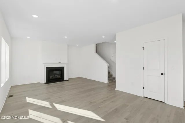 a view of an empty room with a fireplace