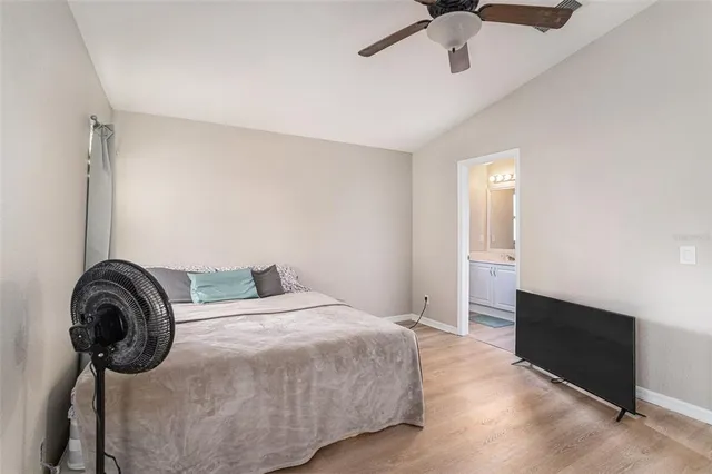 a bedroom with a bed and a ceiling fan