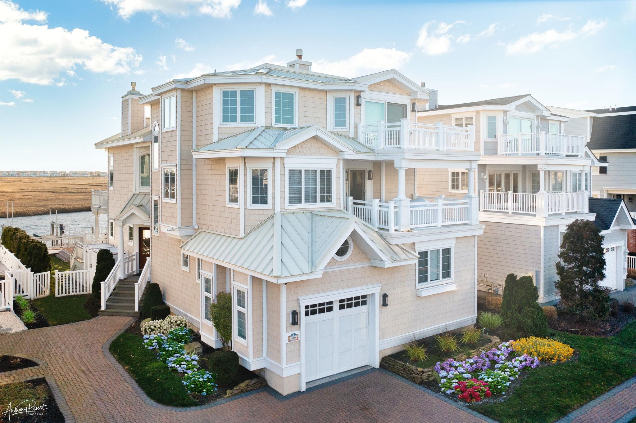 526 7th Street Avalon, NJ 08202 - Photo 1 of 24 a front view of a house with a yard