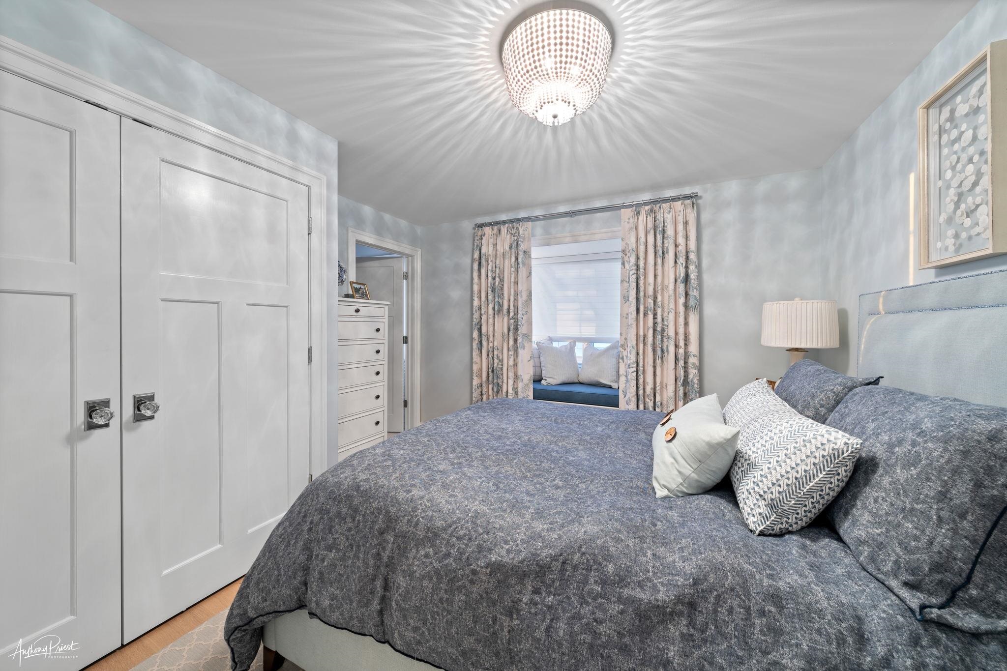 526 7th Street Avalon, NJ 08202 - Photo 14 of 24 a bedroom with a large bed and a chandelier
