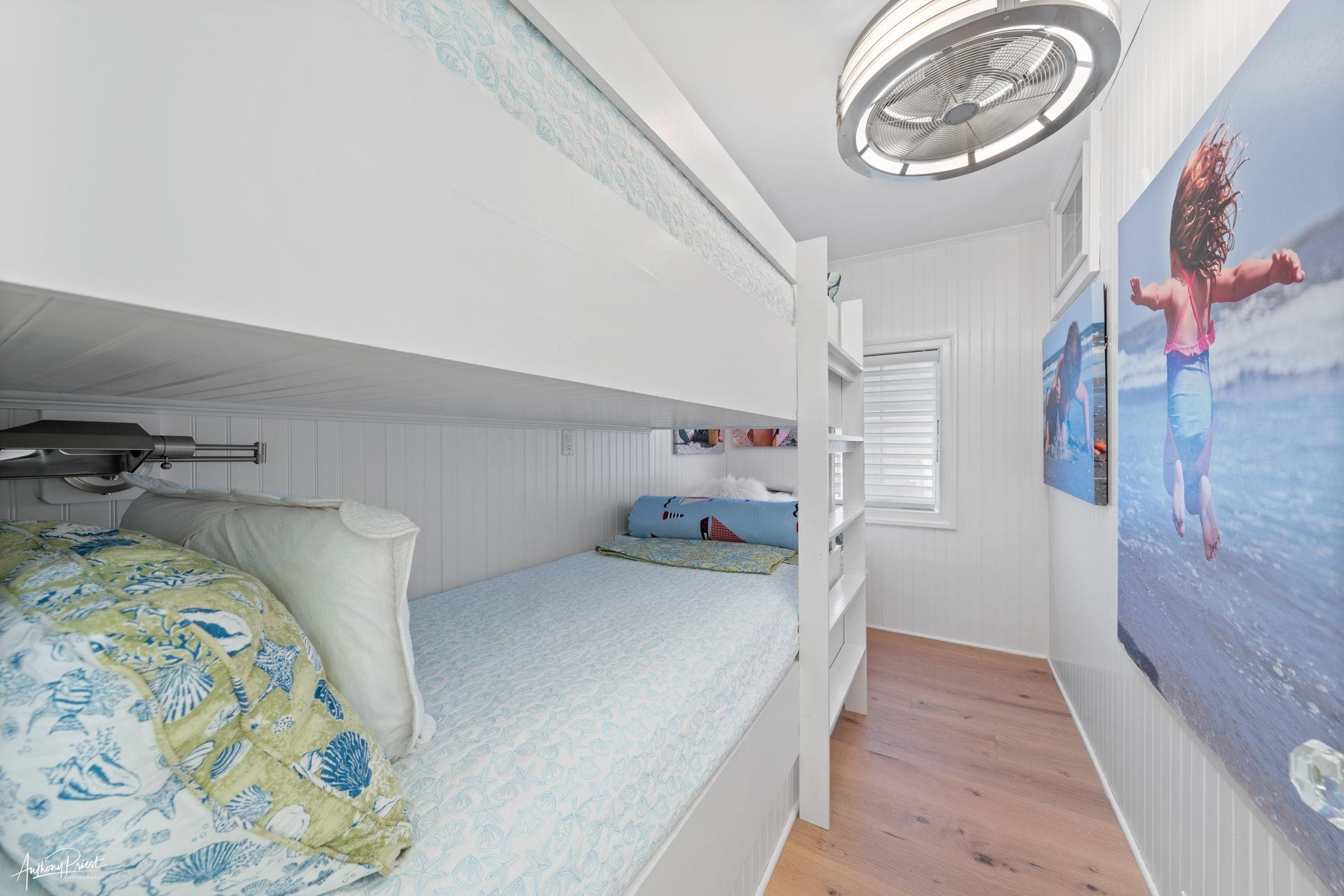 526 7th Street Avalon, NJ 08202 - Photo 15 of 24 a bedroom with a bed and a chandelier