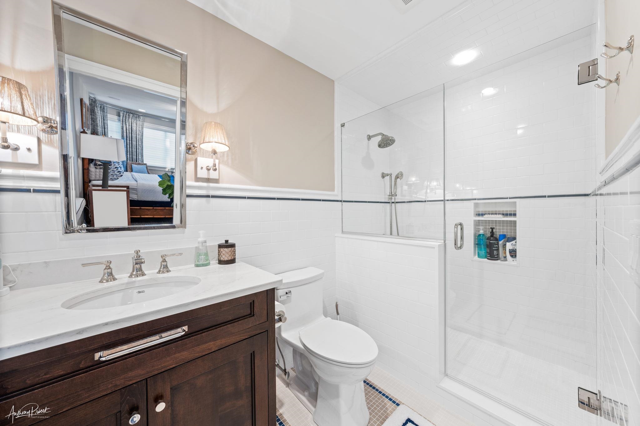 526 7th Street Avalon, NJ 08202 - Photo 17 of 24 a bathroom with a sink a toilet and shower