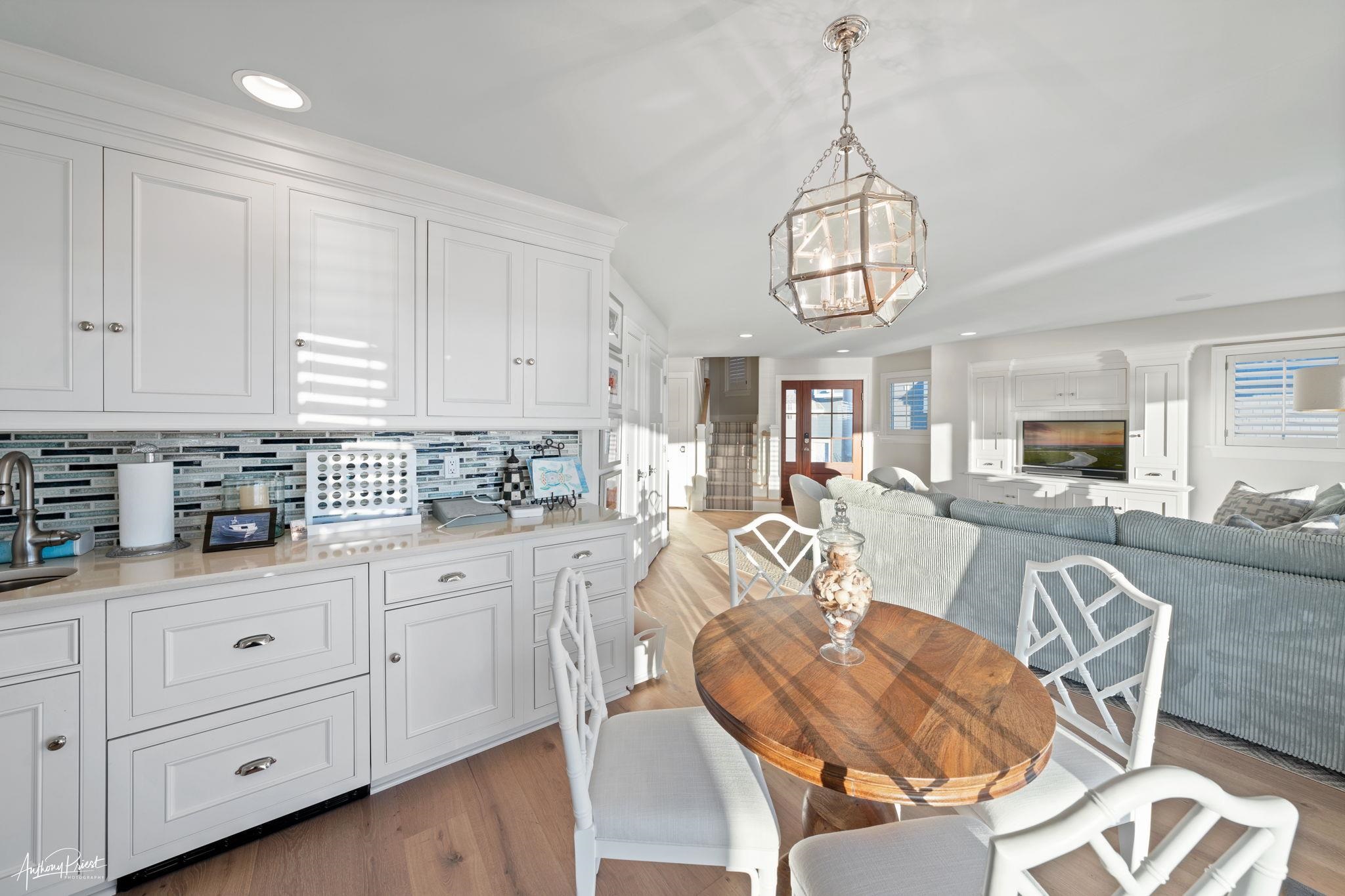 526 7th Street Avalon, NJ 08202 - Photo 6 of 24 a view of a dining room with furniture a chandelier and wooden floor