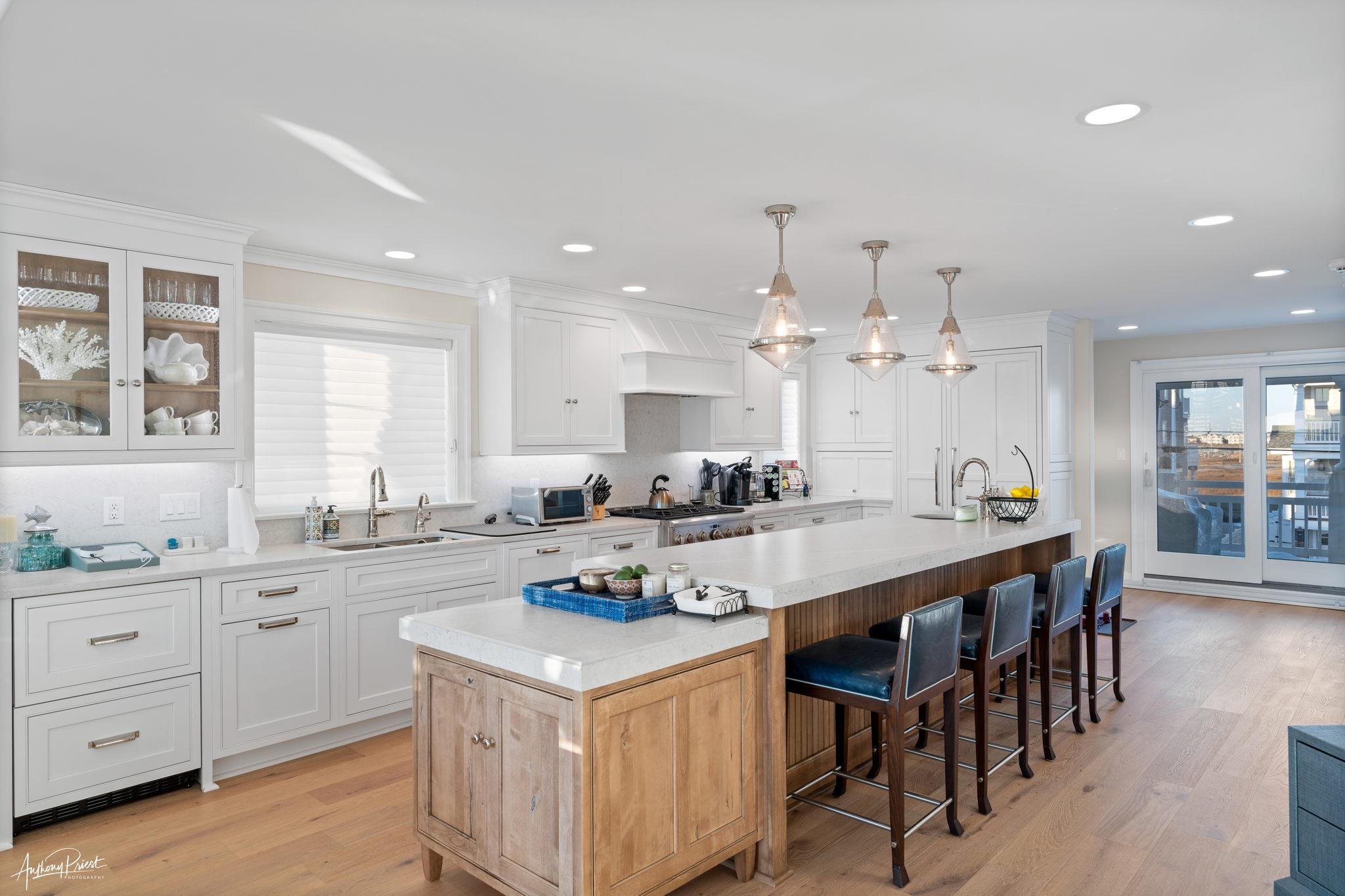 526 7th Street Avalon, NJ 08202 - Photo 8 of 24 a kitchen with a dining table chairs cabinets and wooden floor
