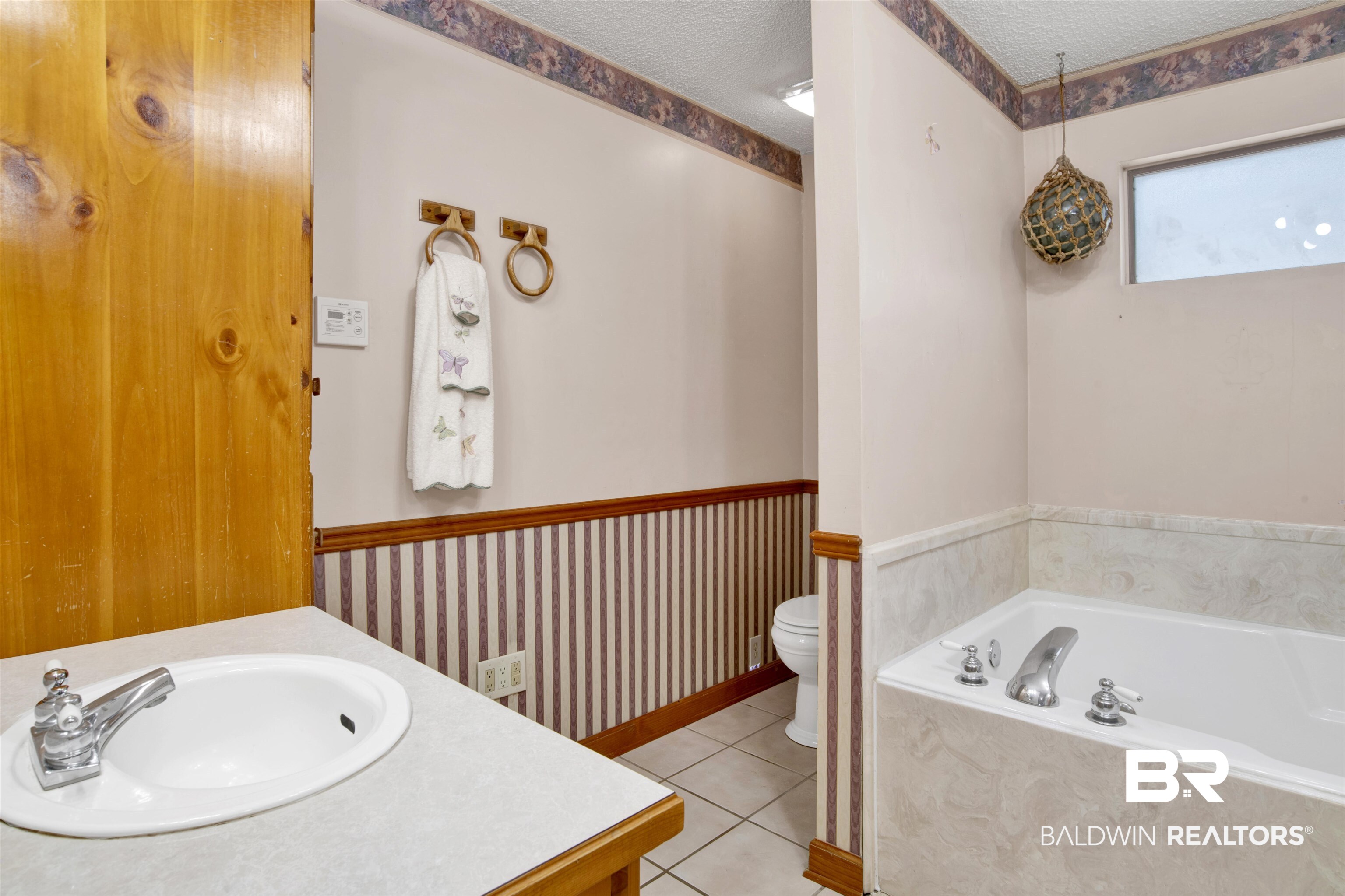 4890 Red Creek Road Semmes, AL 36575 - Photo 21 of 47 Bathroom featuring tile patterned floors, tiled bath, toilet, vanity, and a textured ceiling