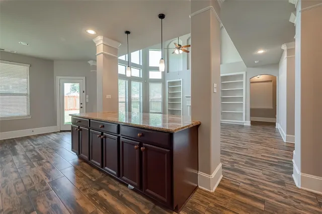 a kitchen with stainless steel appliances granite countertop a stove and a microwave