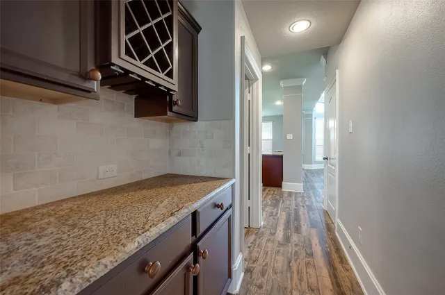 a view of a room with wooden floor and a window