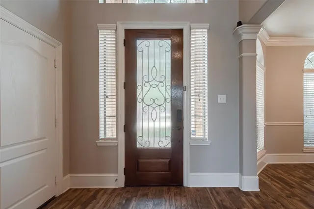 a view of bedroom with window and wooden floor