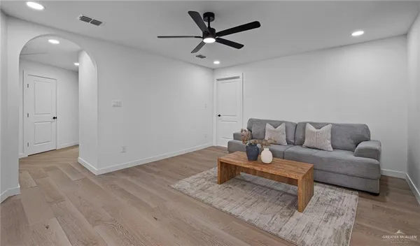 a living room with furniture and a ceiling fan