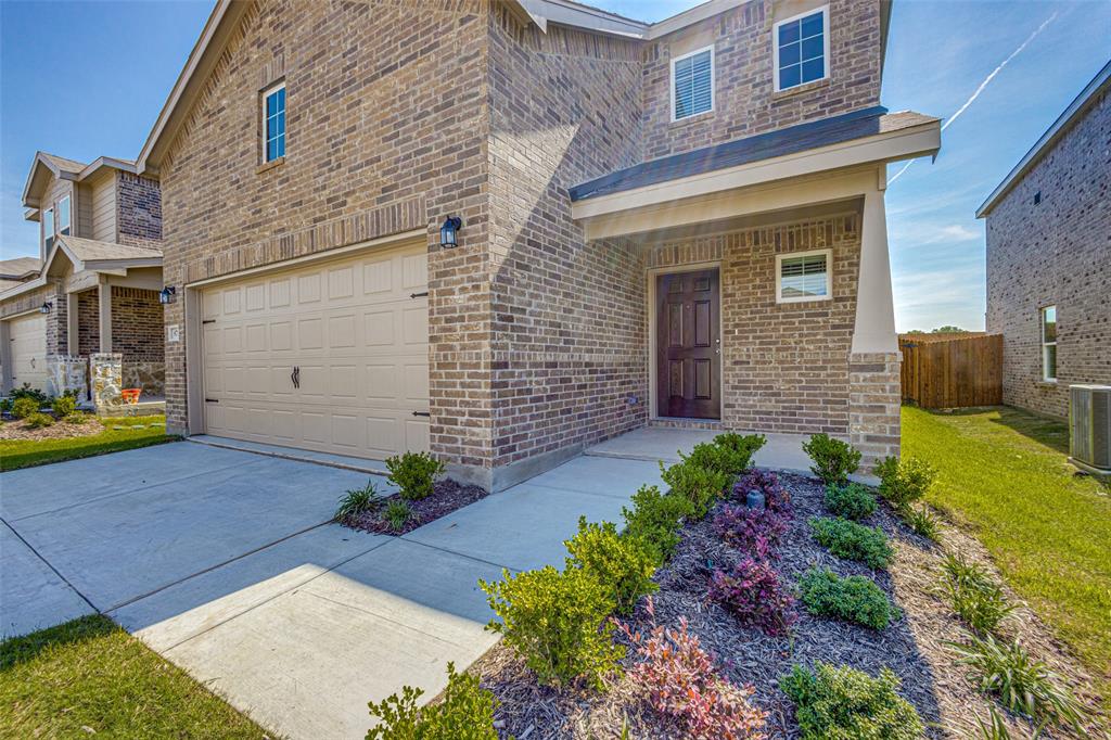 877 Table Rock Street Princeton, TX 75407 - Photo 1 of 25 a front view of a house with garden