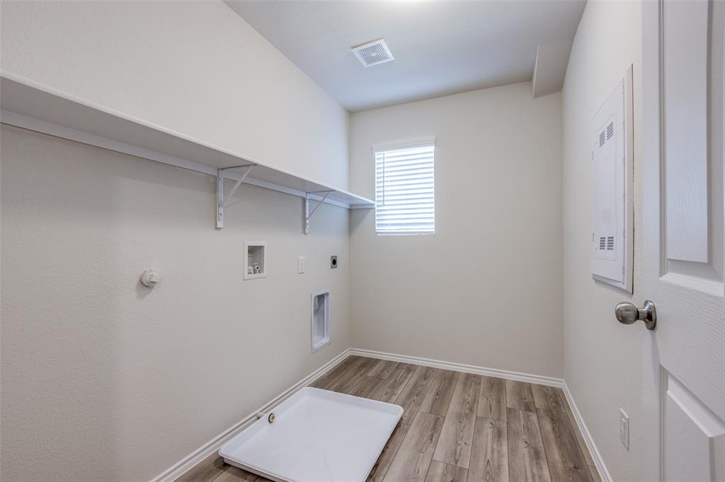 877 Table Rock Street Princeton, TX 75407 - Photo 16 of 25 a view of small space with wooden floor and fan