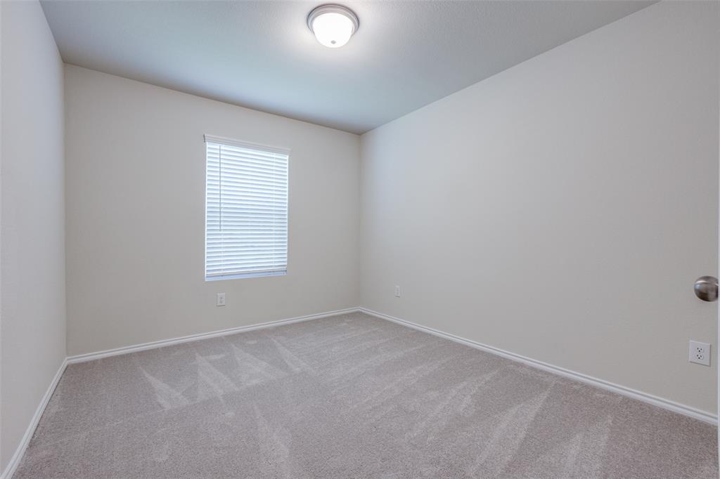 877 Table Rock Street Princeton, TX 75407 - Photo 17 of 25 an empty room with a window