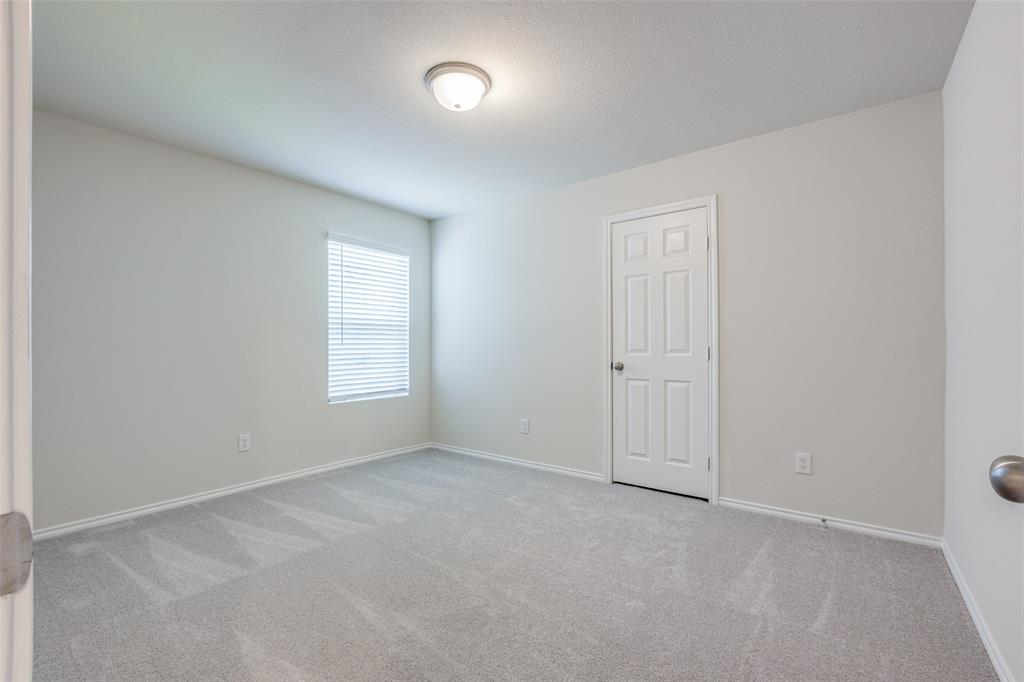 877 Table Rock Street Princeton, TX 75407 - Photo 21 of 25 an empty room with a window