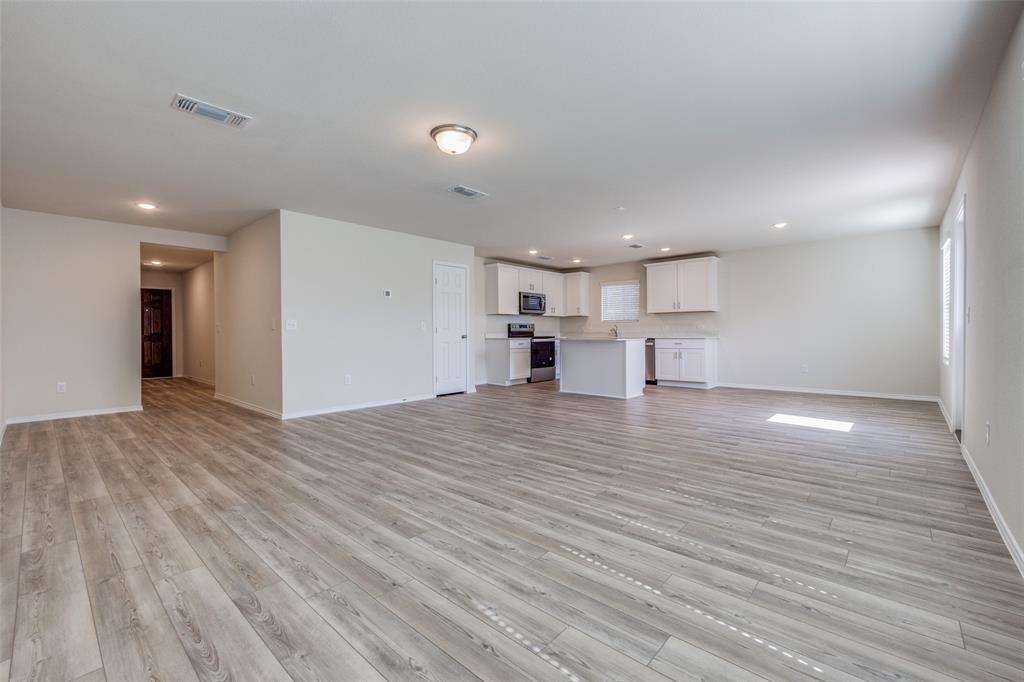877 Table Rock Street Princeton, TX 75407 - Photo 7 of 25 a view of empty room with wooden floor
