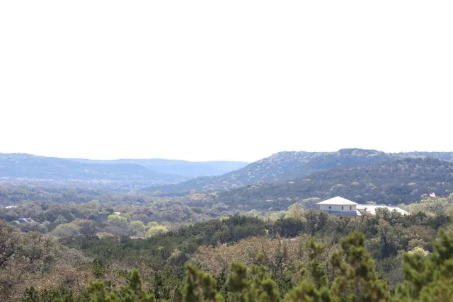 a view of a mountain in the distance in a field