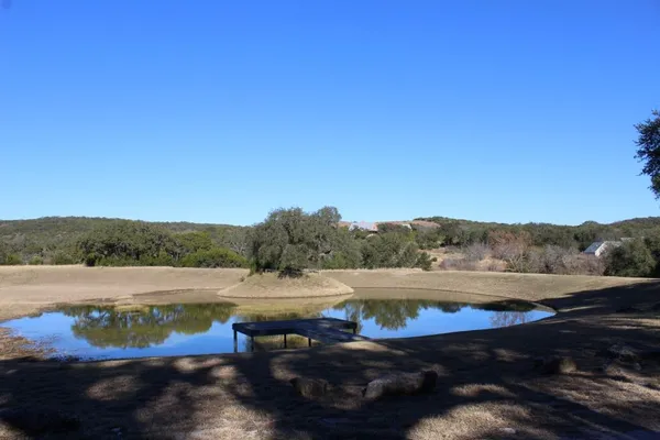 a view of lake with green field
