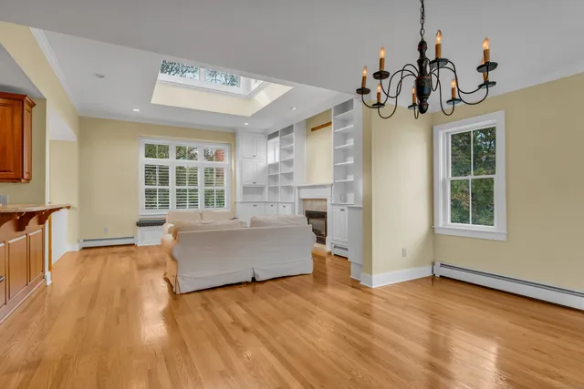 a view of a living room and kitchen with windows