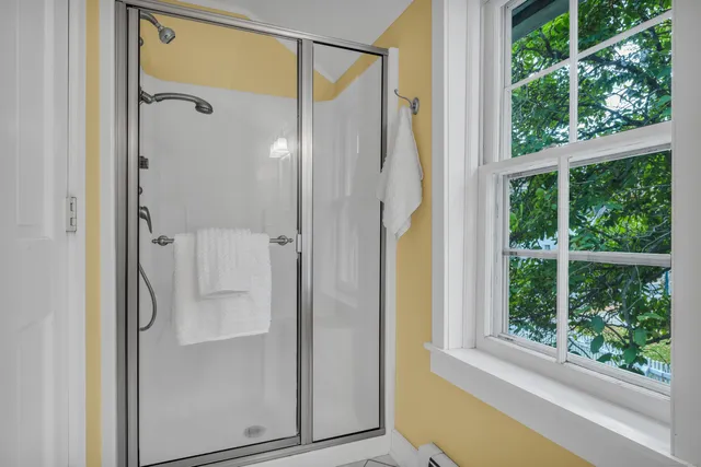 a bathroom with a glass shower door