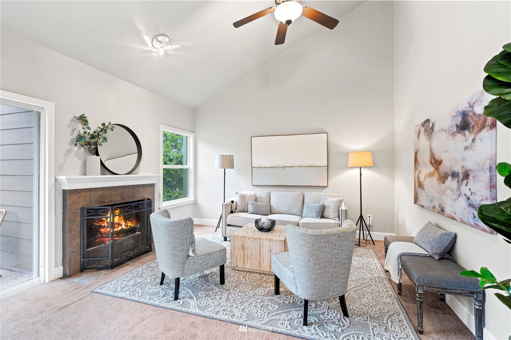 820 Cady Road, Unit C302 Everett, WA 98203 - Photo 2 of 25 a living room with furniture a fireplace a chandelier and a flat screen tv